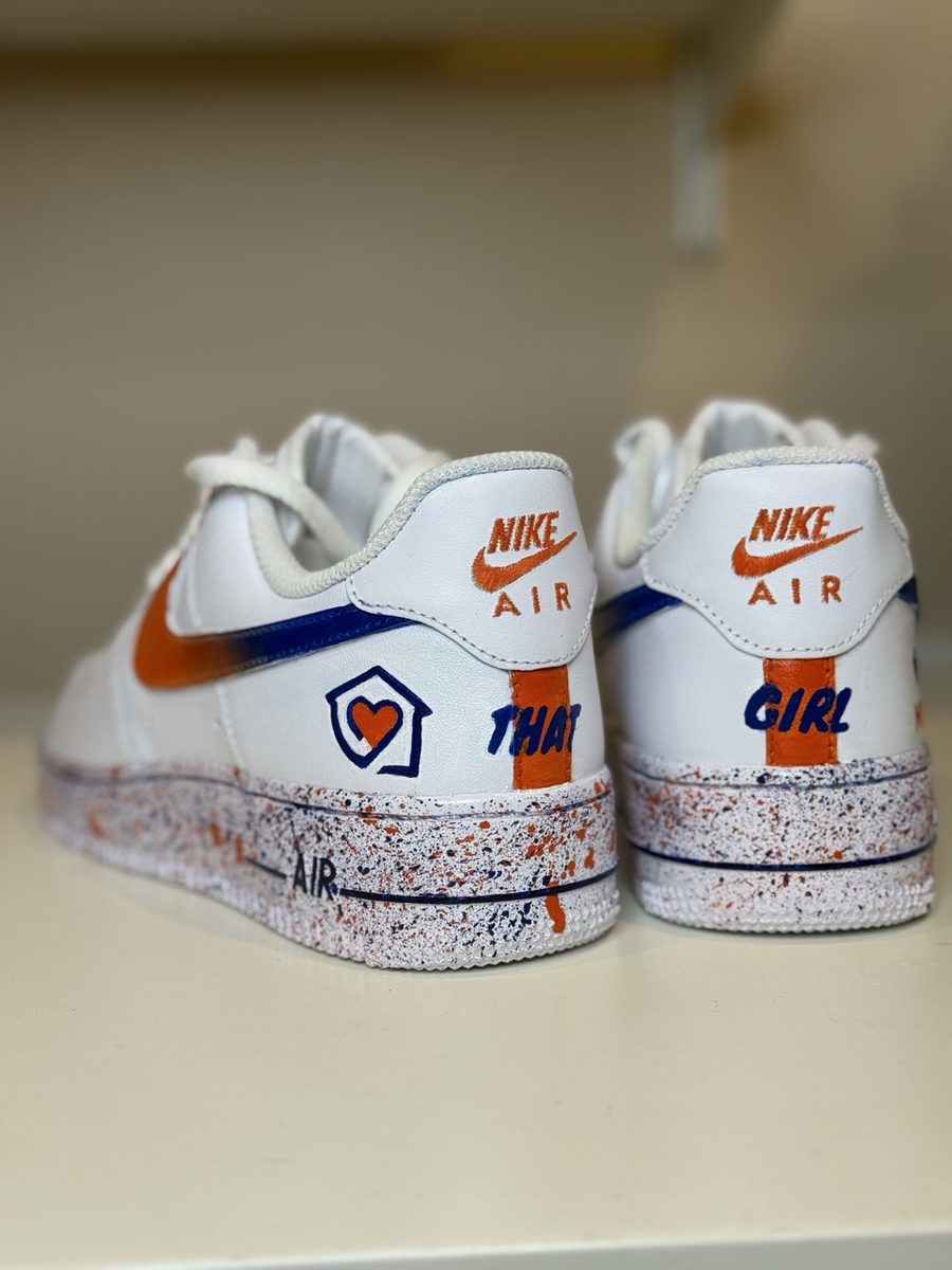 Heels of the orange and blue company logo sneakers