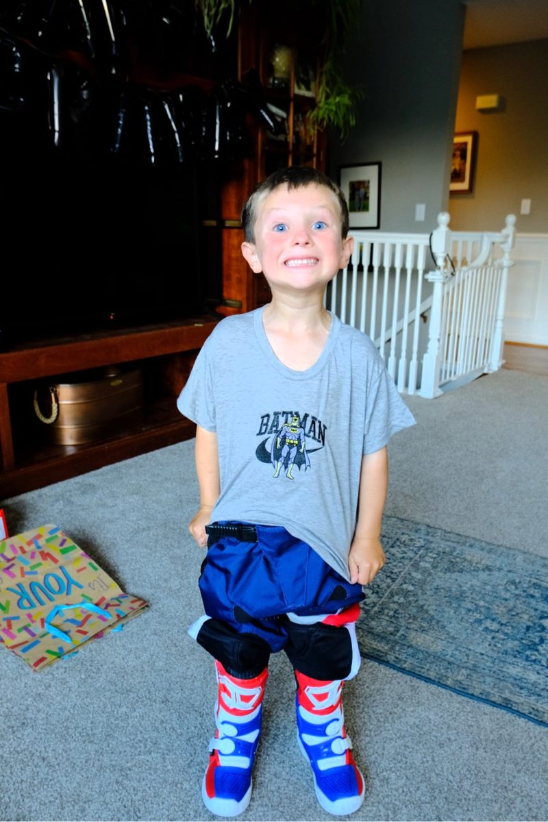 Smiling boy in a custom embroidered superhero tee