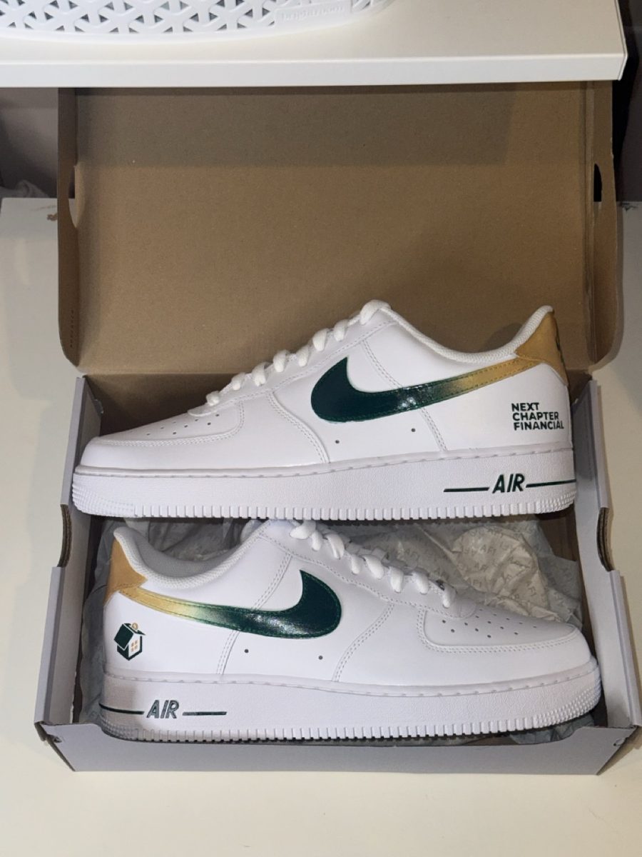 Green and gold sneakers painted with a company logo