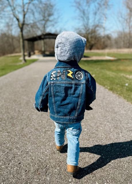 Toddler walking in a hand-painted jean jacket