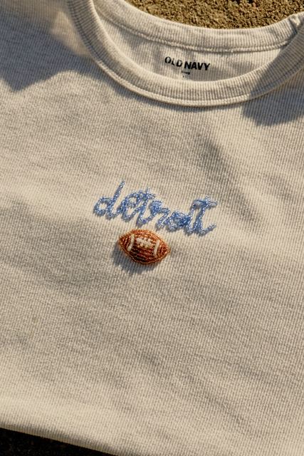 Close-up of the beaded Detroit script and football